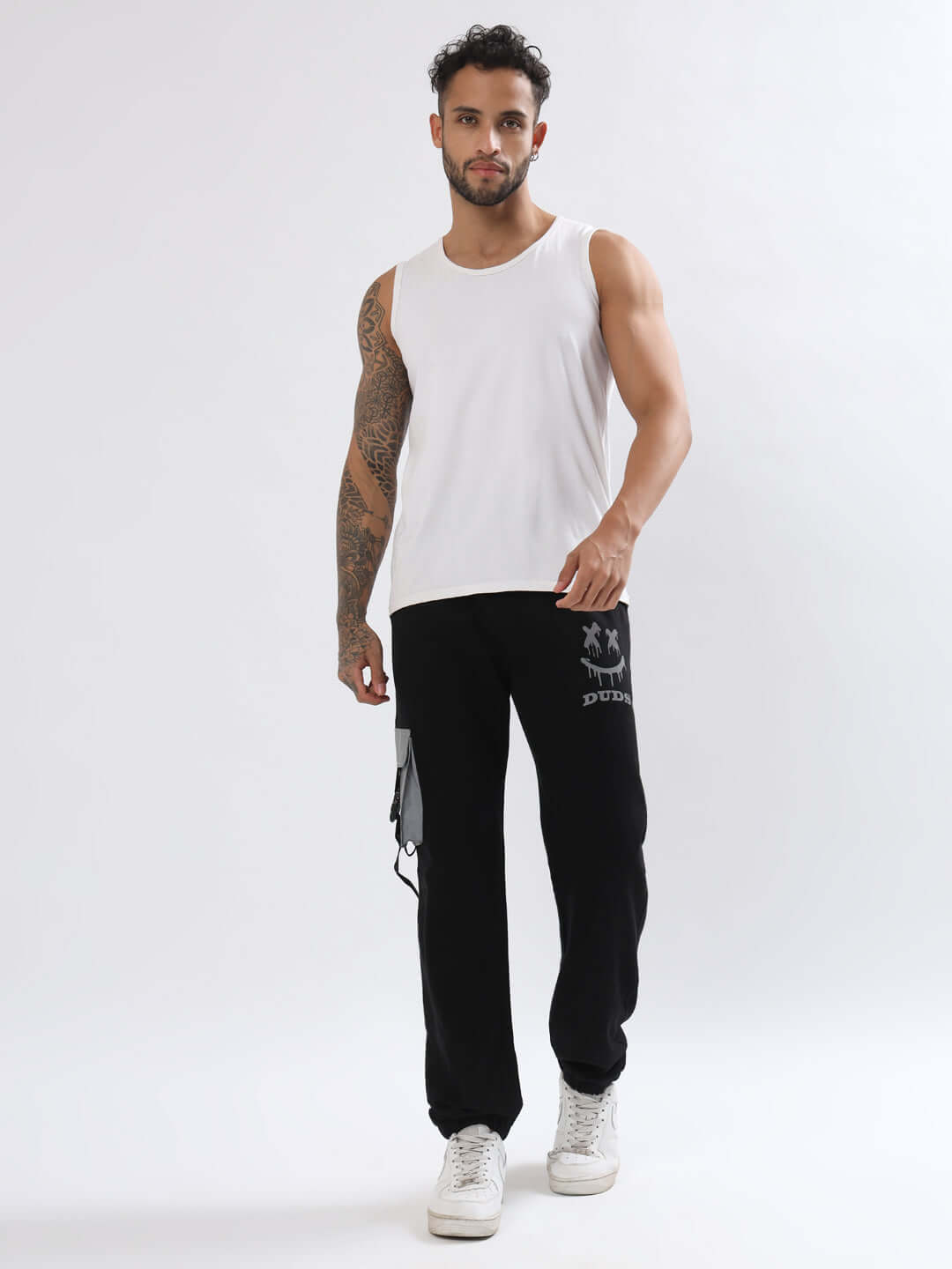 Man wearing black DUDS Smiley Reflector Cargo Jogger, showcasing comfortable and stylish design for made-to-order custom fit options.
