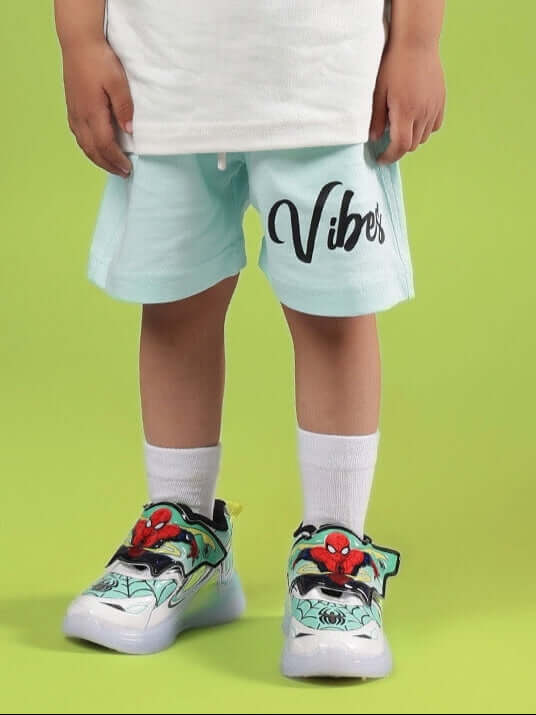 Child wearing DUDS VIBES SHORTS FOR BOYS & GIRLS SKY BLUE with vibrant sneakers.