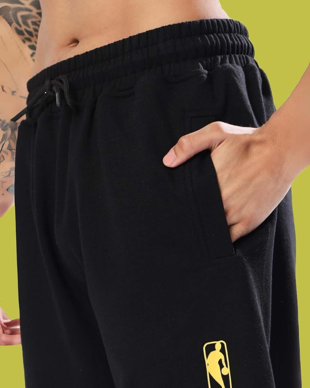 Close-up of a person wearing black DUKE RELAXED PANT JOGGER with side pocket detail and elastic waistband, highlighting comfort and style.