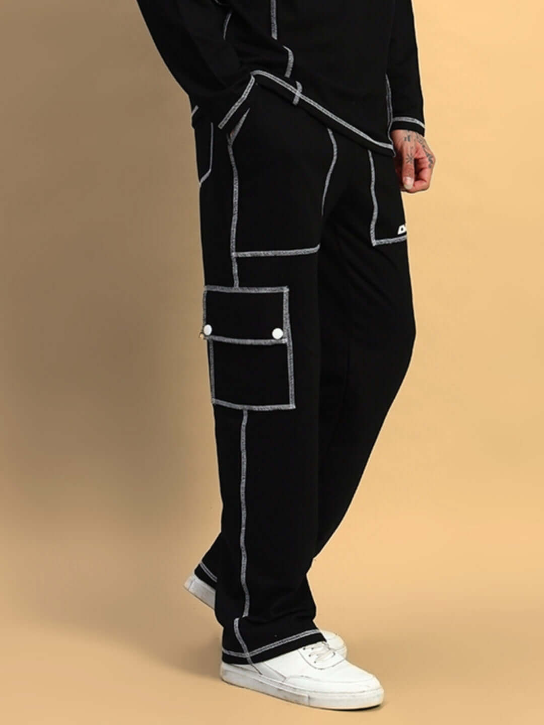 Black dynamic 5-pocket cargo pant made by DUDS, shown with white stitching details, worn with white sneakers.