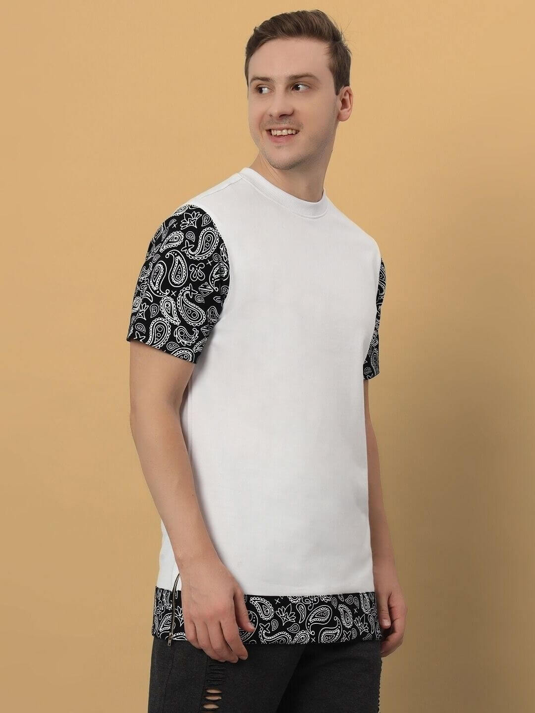 Beasley oversized white T-shirt with patterned sleeves and hem, made of premium cotton blend, modeled by a person against a beige background.