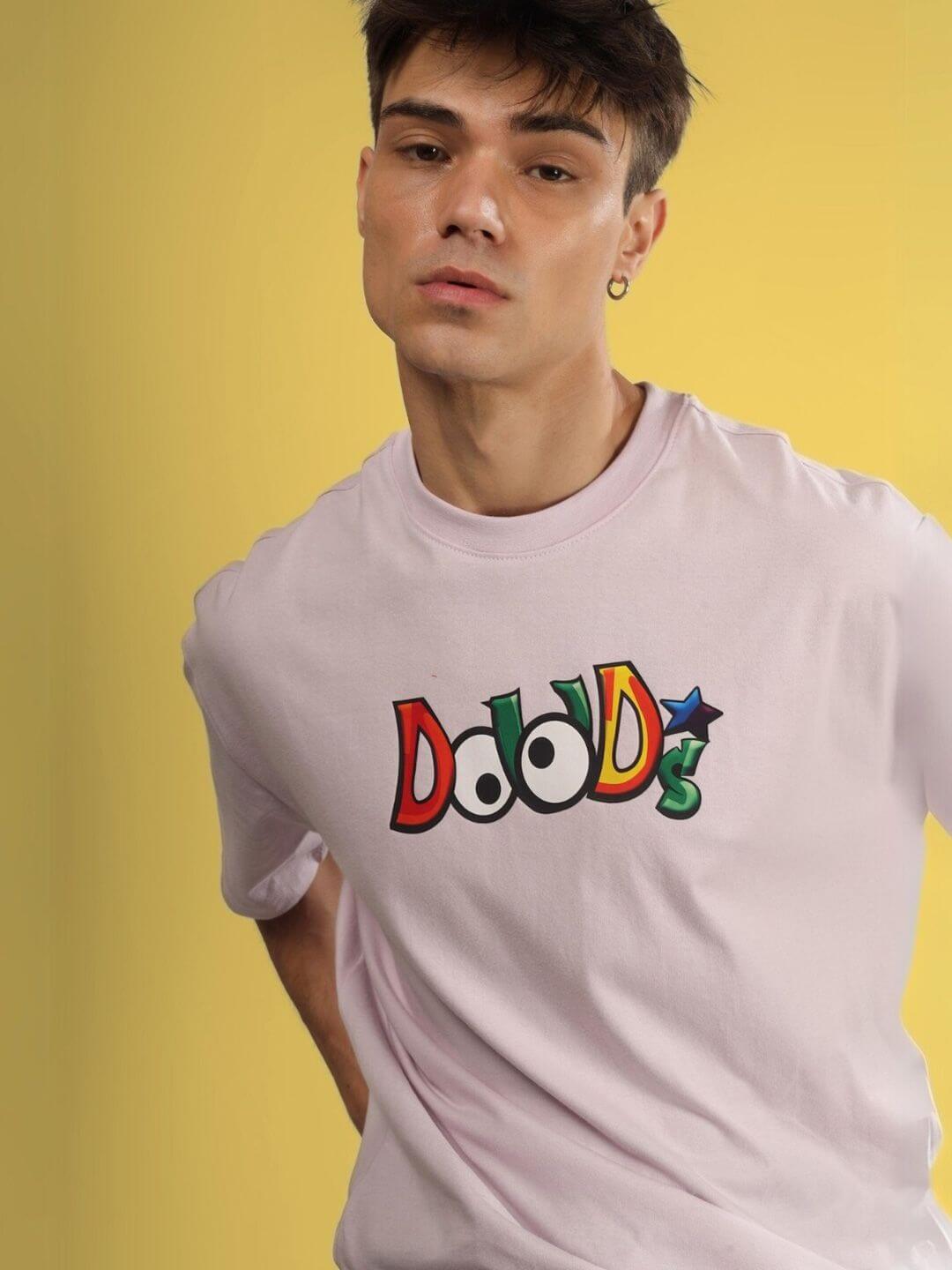 Model wearing DUDS MONSTER OVER-SIZED T-SHIRT PALE PINK, showcasing heavy gauge fabric and colorful logo.