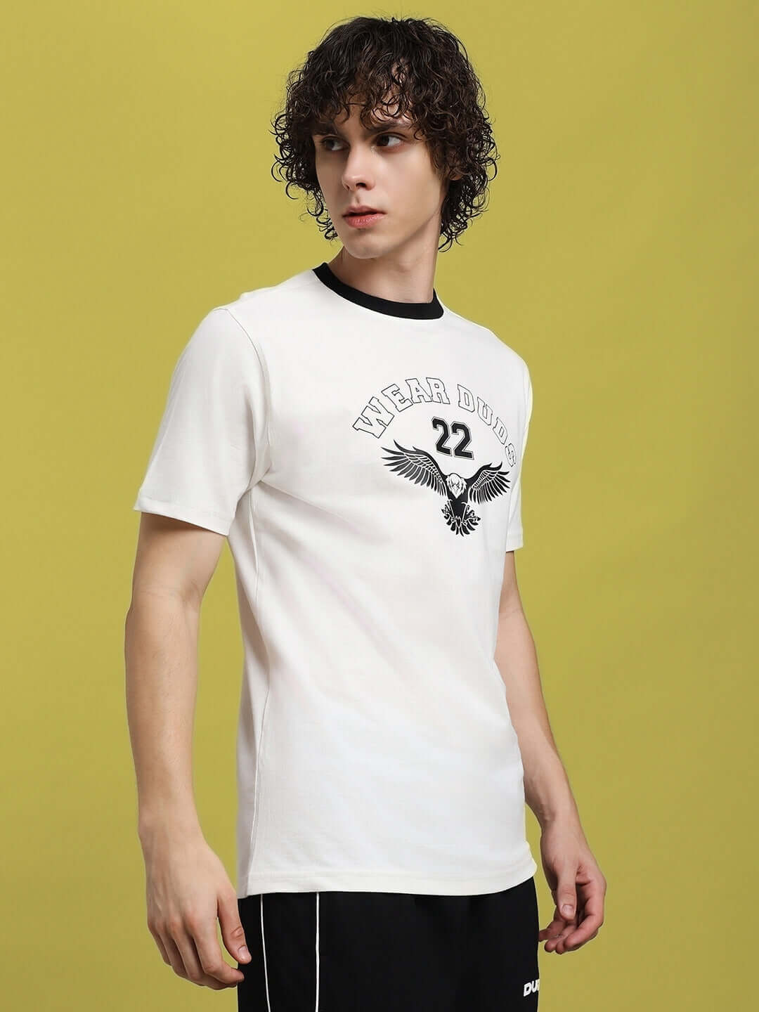 Model wearing Eagle Wings Regular Fit T-shirt in white, made of 100% cotton. Features an eagle graphic, suitable for casual wear.