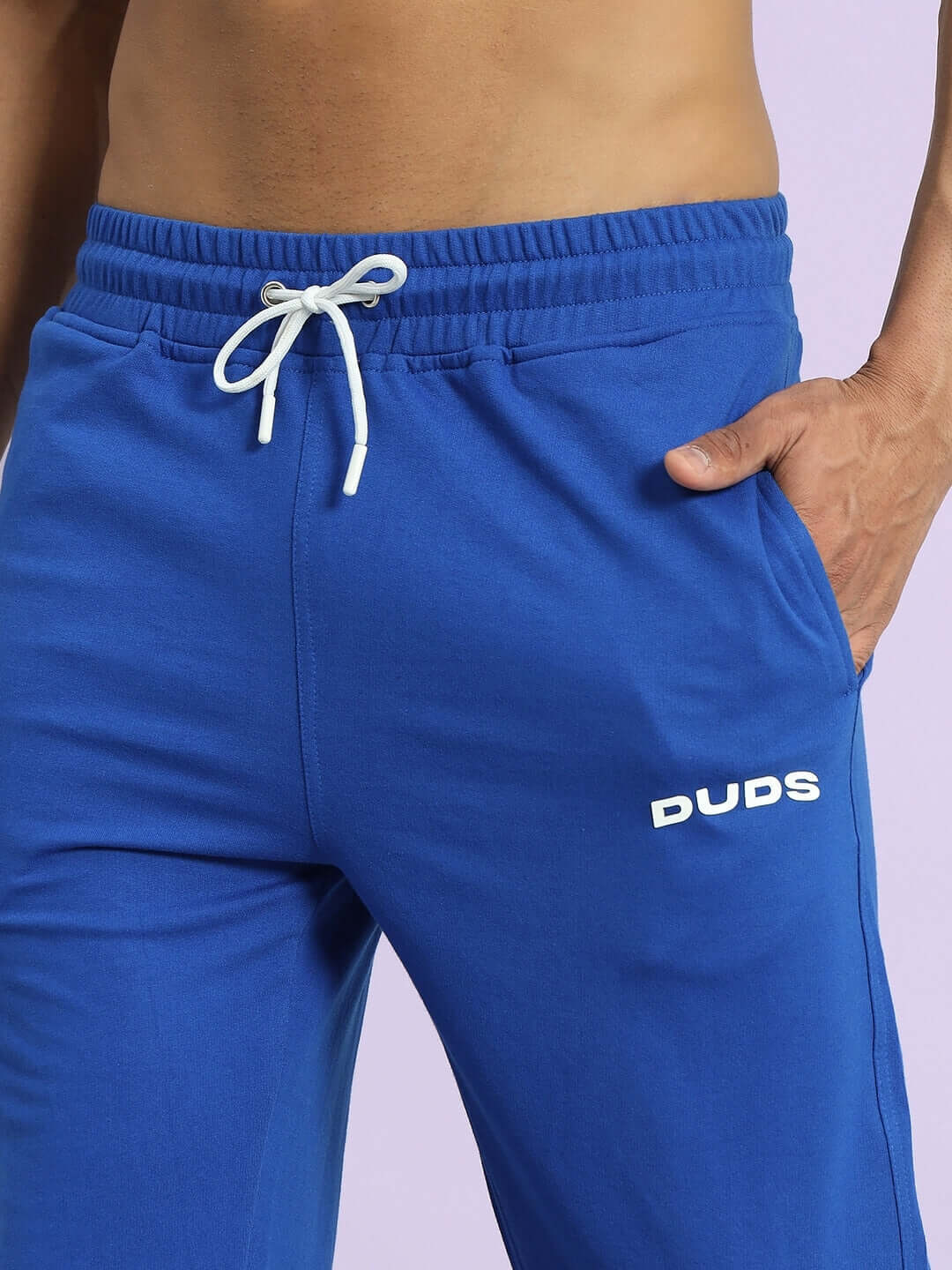 Royal blue joggers by DUDS with white drawstring and branding, offering custom size options for a tailored fit.
