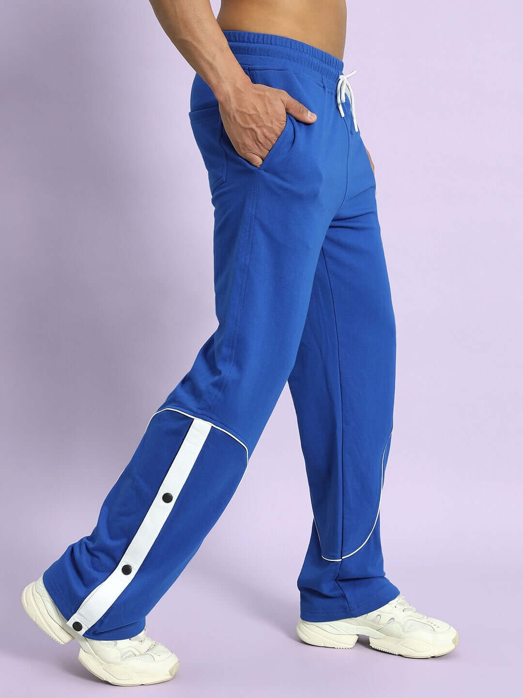Man wearing EDDIE CONTRAST JOGGERS in royal blue with white stripe details, styled for custom fit and made by DUDS tailors.