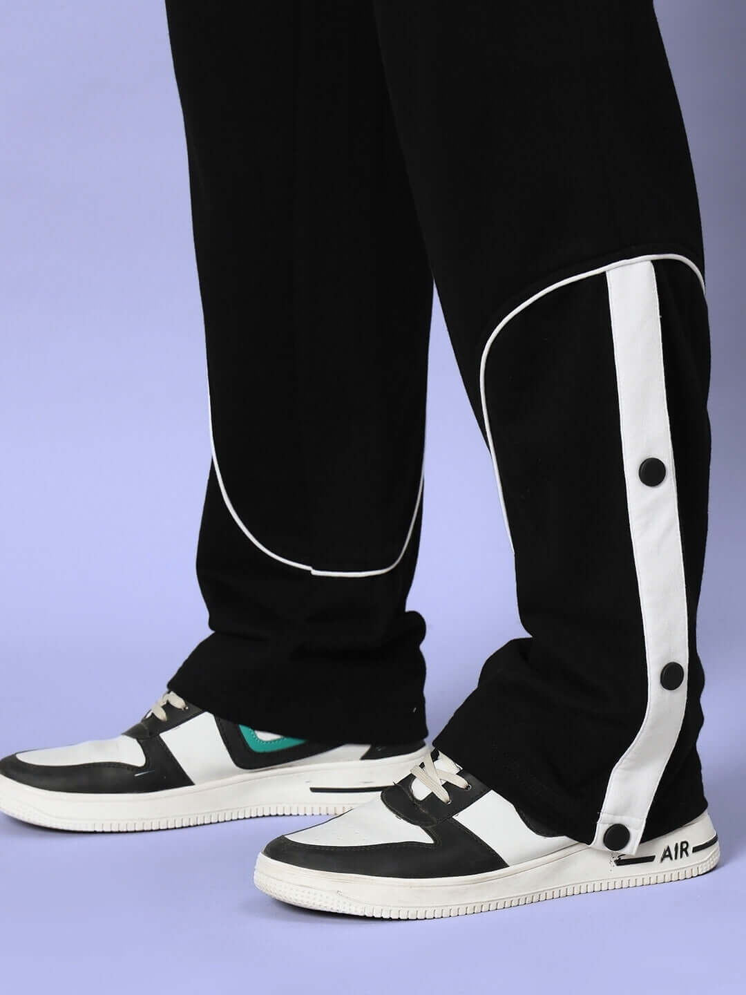 Black Eddie Contrast Joggers with white side stripe and button detail, worn with sneakers. Available for custom fit orders.