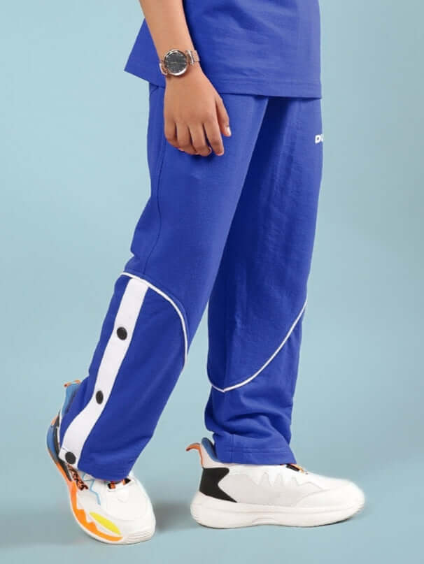 Child wearing EDDIE JOGGER FOR BOYS & GIRLS BLUE with sneakers and watch, demonstrating comfortable fit and style.