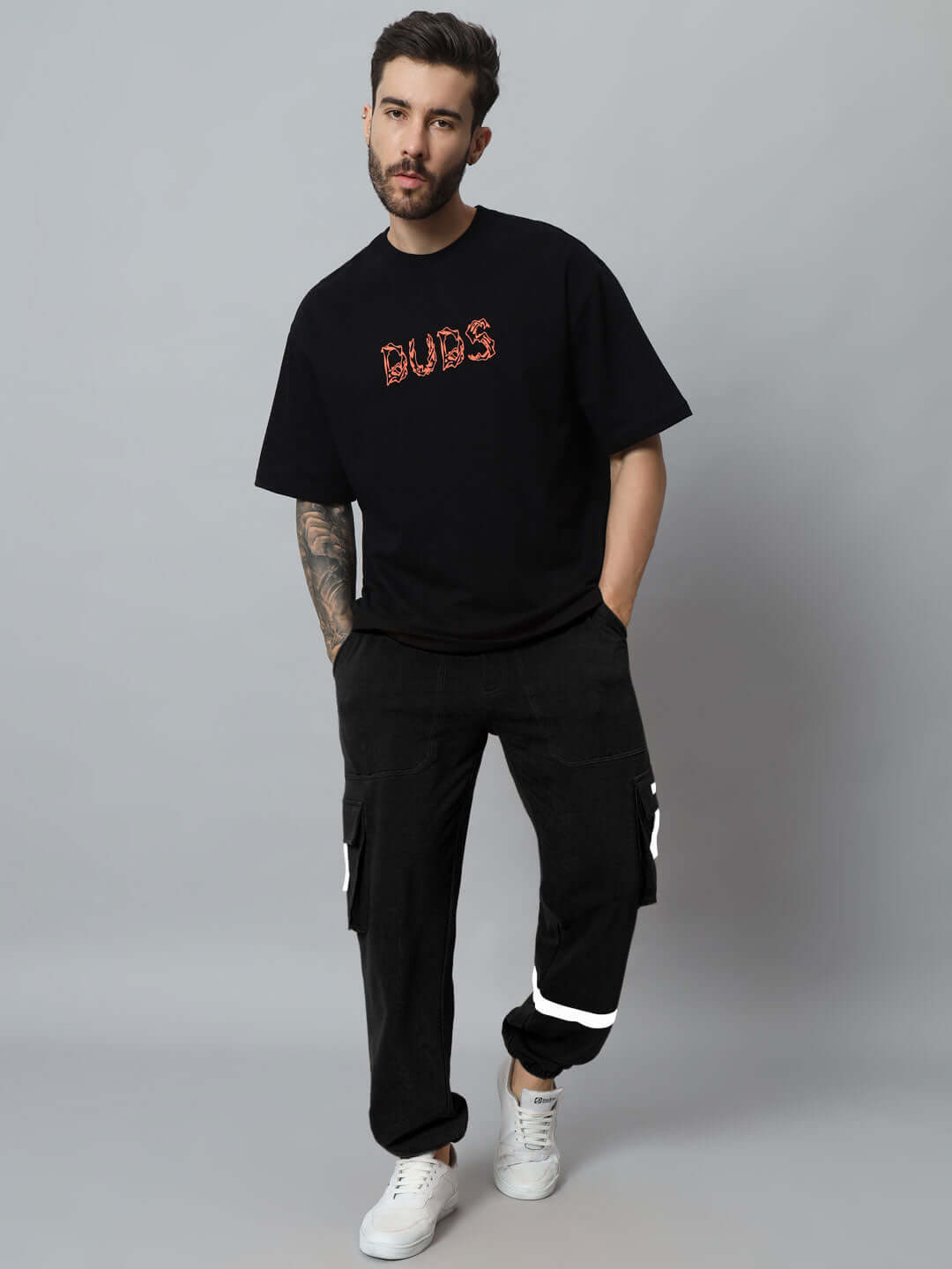 Model wearing EDIFICE relaxed fit black cargo pants by DUDS, showcasing custom-fit option and casual streetwear style.