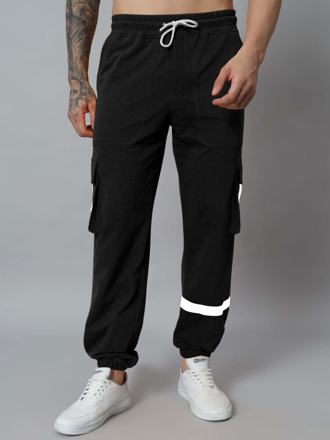 Model wearing EDIFICE relaxed fit black cargo pants with drawstring, showcasing casual style and functionality.