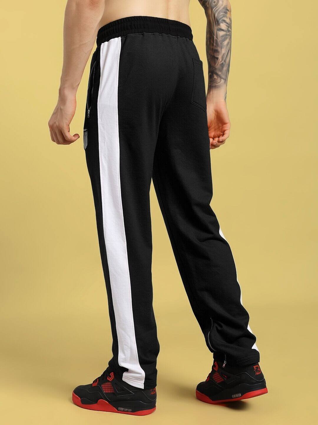 Back view of ELEGANT RELAXED-FIT JOGGERS BLACK with white side stripes.