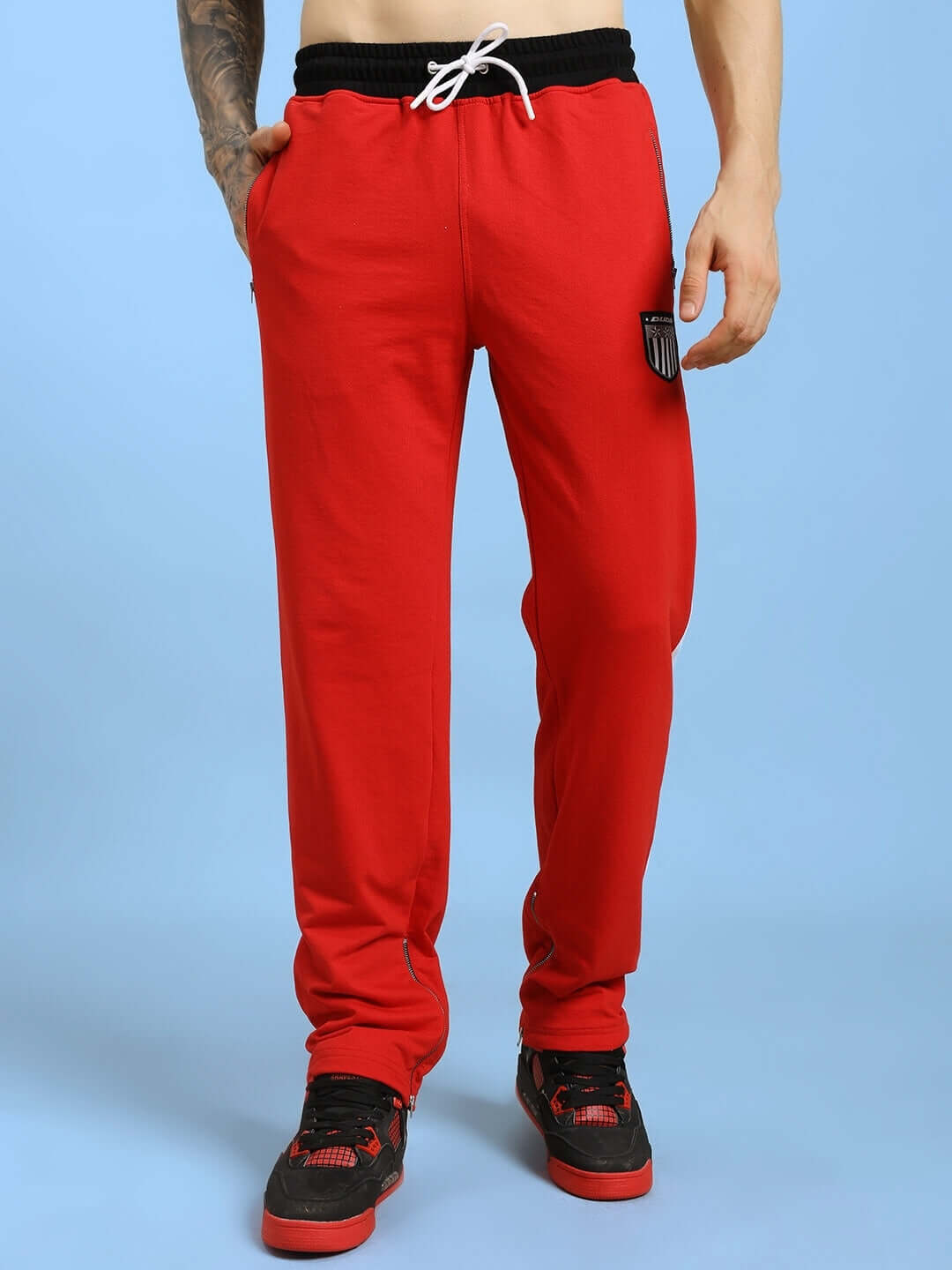 Man wearing ELEGANT RELAXED-FIT JOGGERS RED with black shoes