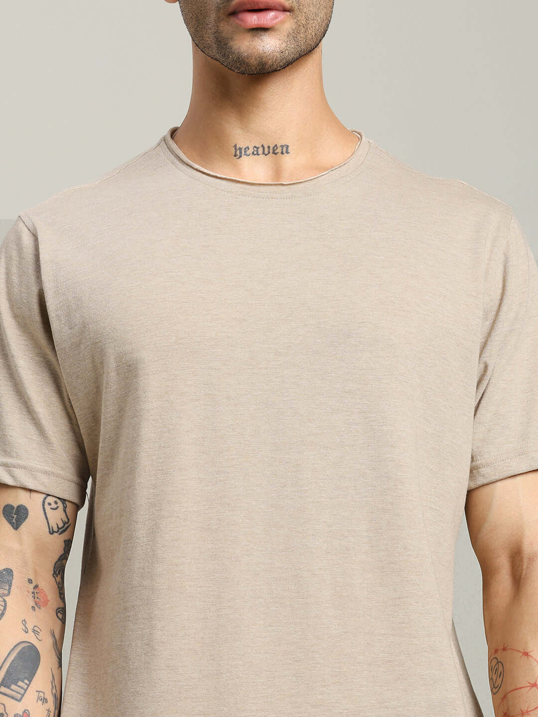 Model wearing ELEX REGULAR FIT T-SHIRT BEIGE, showing the versatile and comfortable design ideal for any modern wardrobe.
