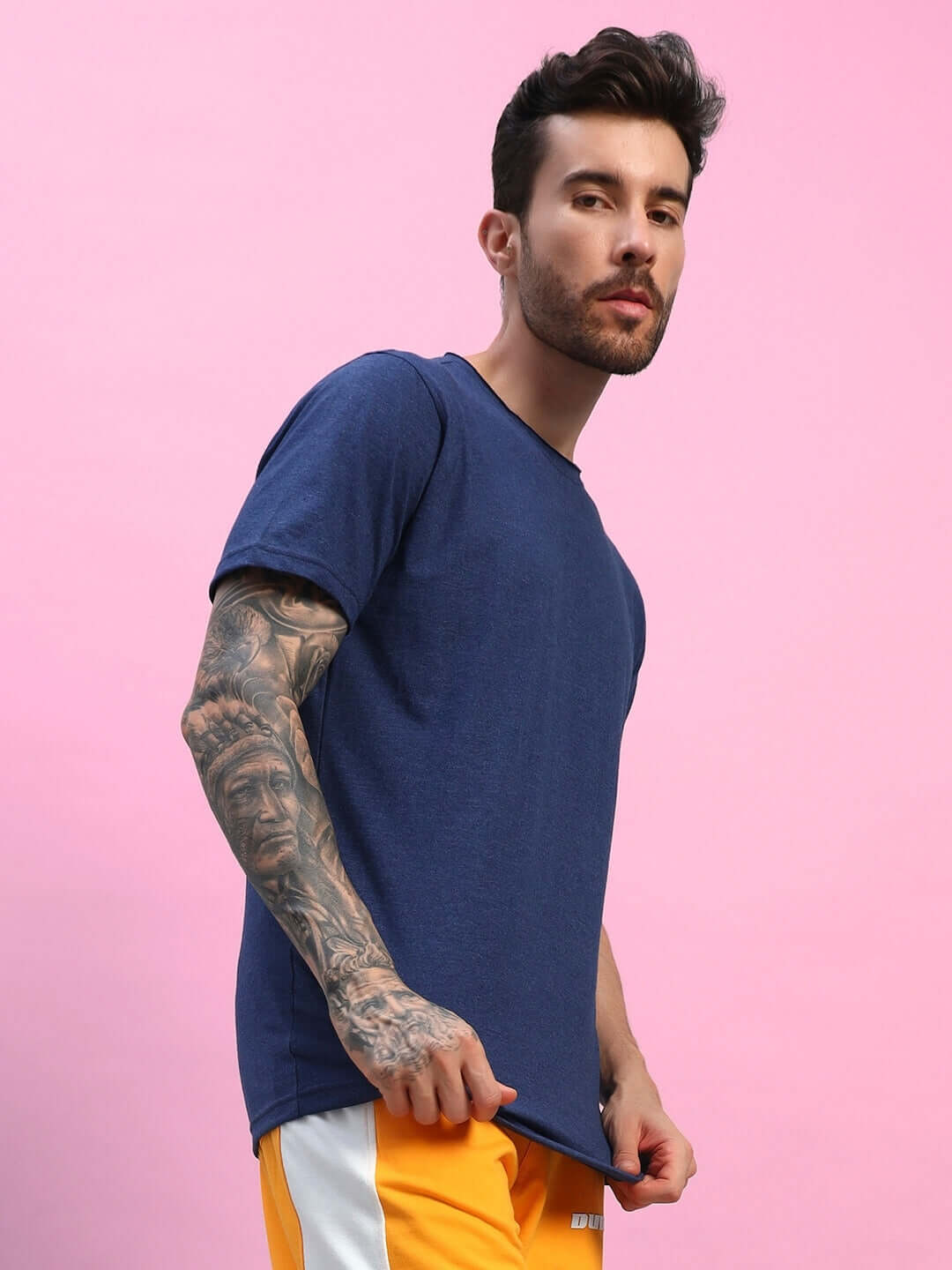 Man wearing ELEX REGULAR FIT T-SHIRT NAVY BLUE against pink background