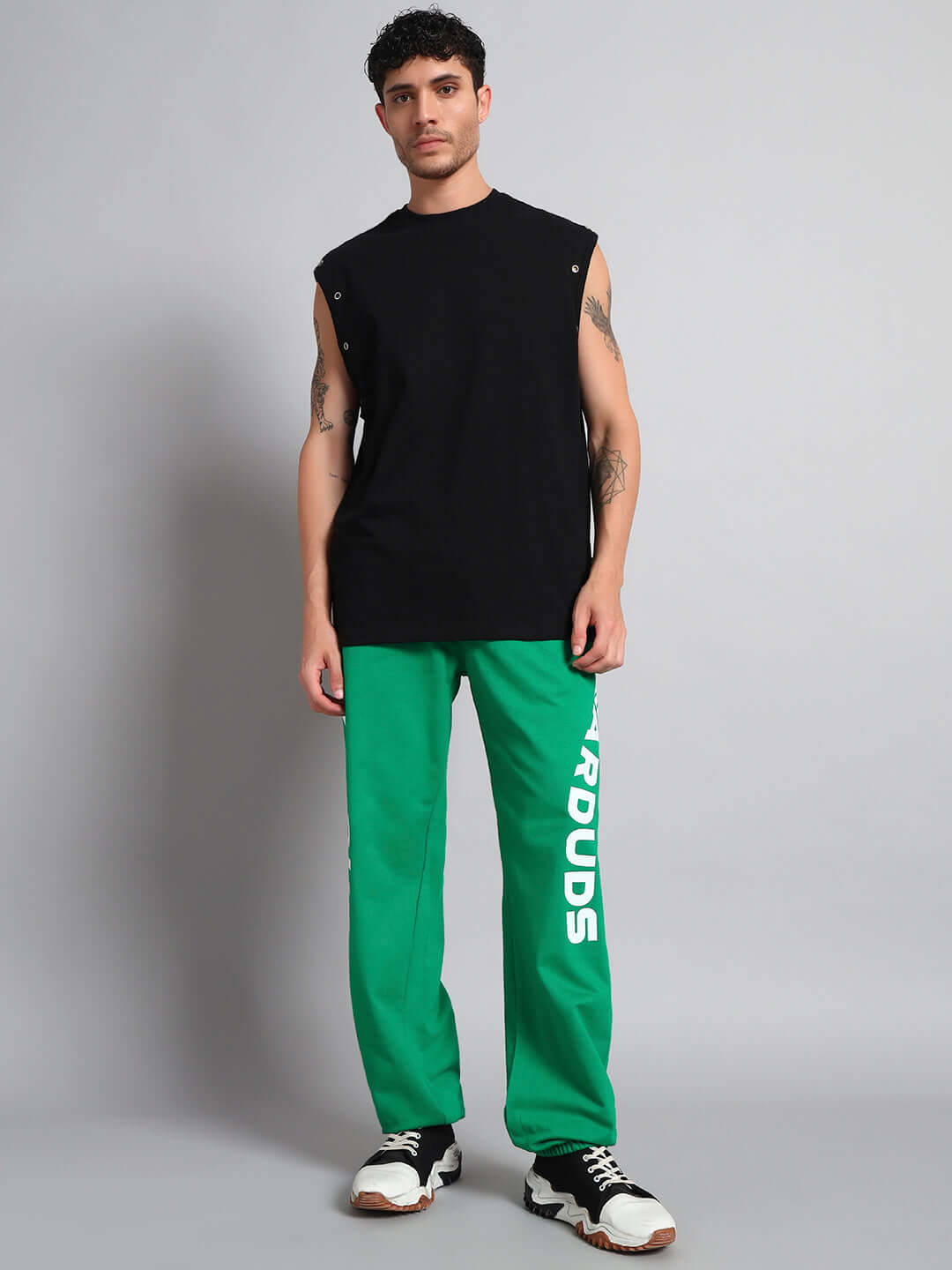 Male model wearing ELLEN RELAXED FIT JOGGER GREEN in a studio, showcasing modern, comfortable style.