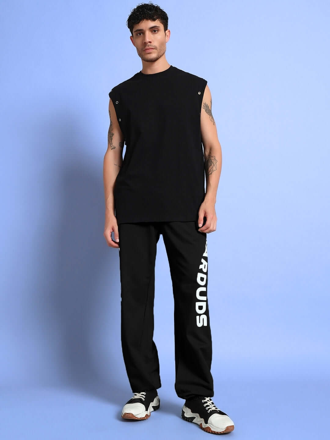 Model wearing ELLEN RELAXED FIT JOGGER BLACK with sleeveless top and sneakers