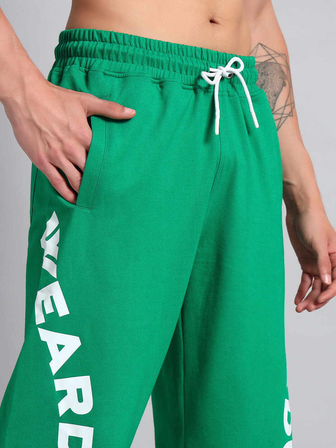 ELLEN RELAXED FIT JOGGER GREEN with side pockets, adjustable drawstring, and bold lettering detail.