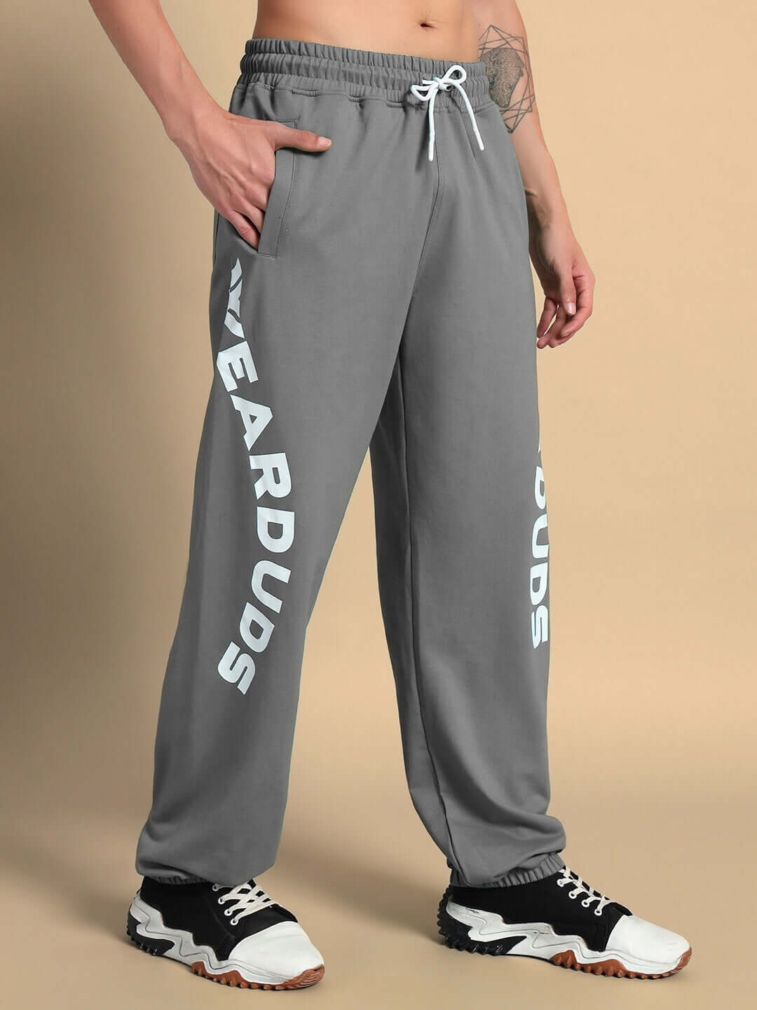 Person wearing ELLEN RELAXED FIT JOGGER GREY with printed design, showcasing comfortable fit and style for everyday wear.