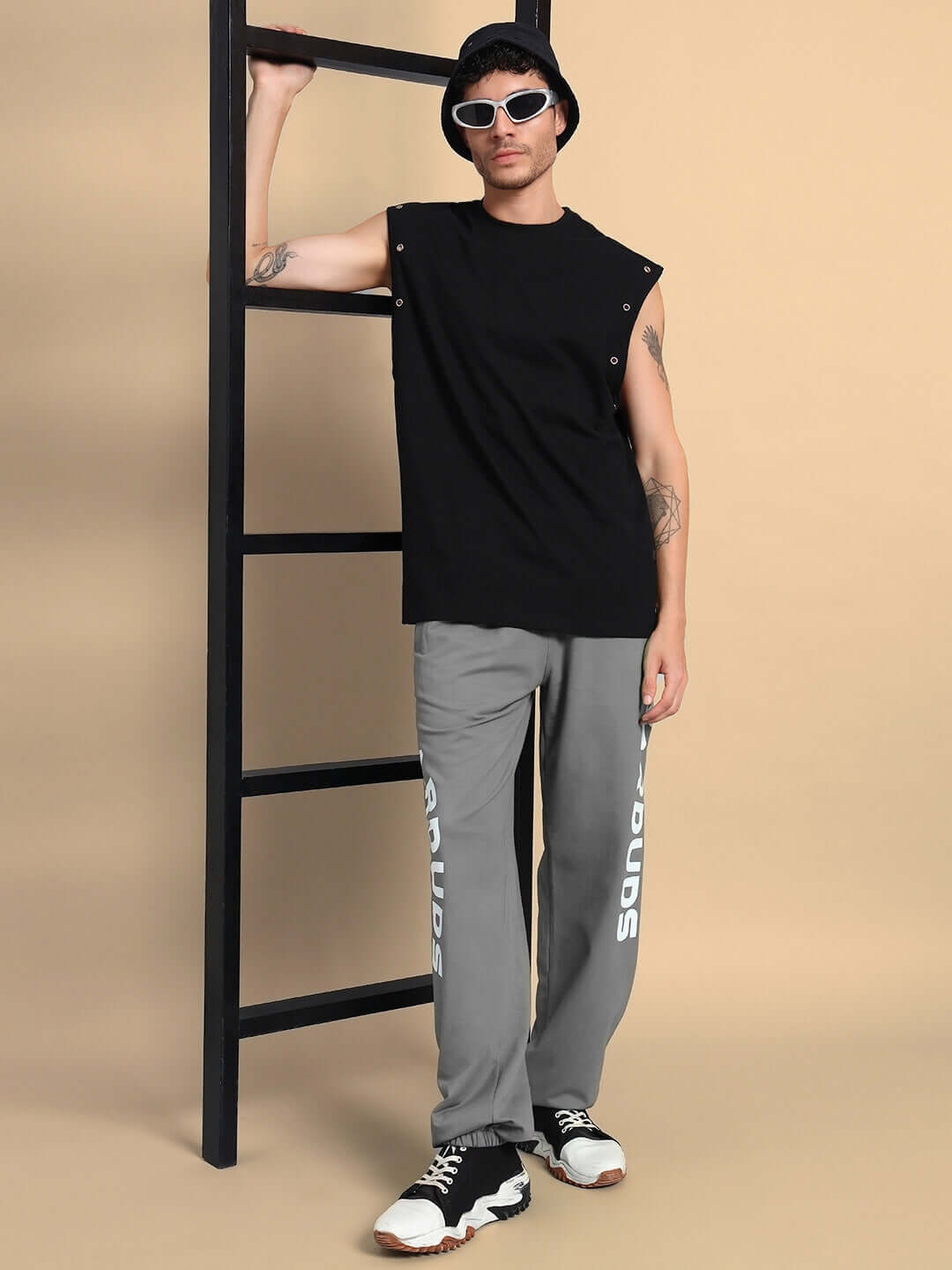 Model wearing ELLEN RELAXED FIT JOGGER GREY with black sleeveless top and sunglasses for casual style.