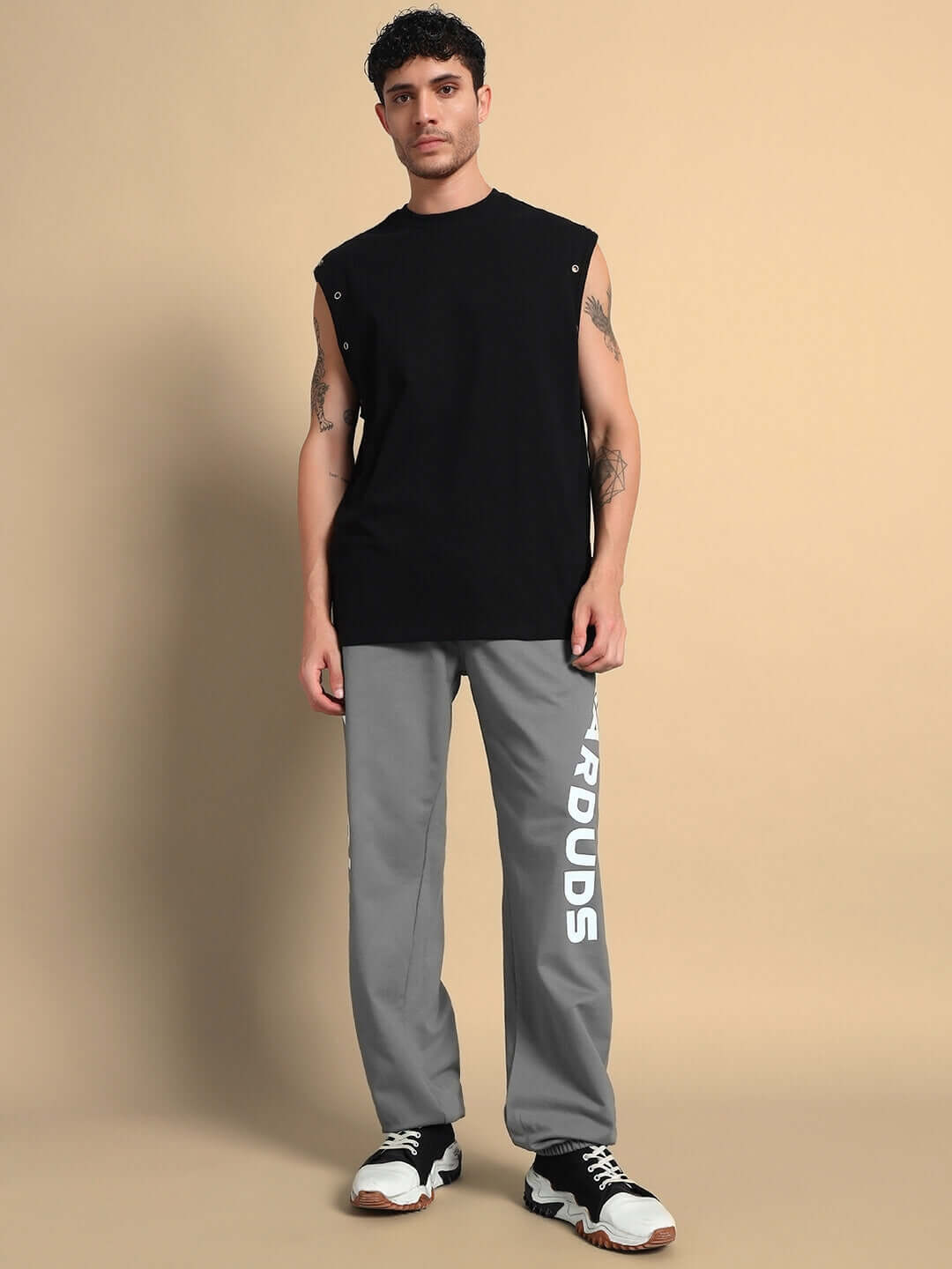 Man wearing ELLEN RELAXED FIT JOGGER GREY with black sleeveless tee, showcasing comfort and style.