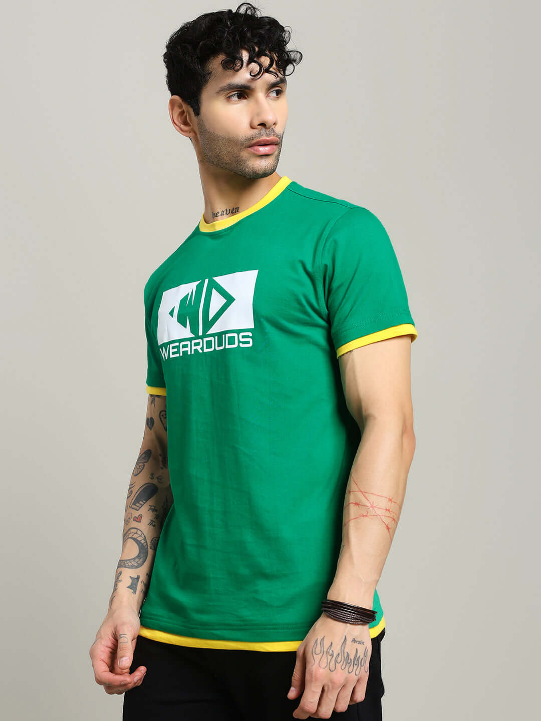Man wearing ELMER REGULAR FIT T-SHIRT GREEN with yellow accents and graphic design