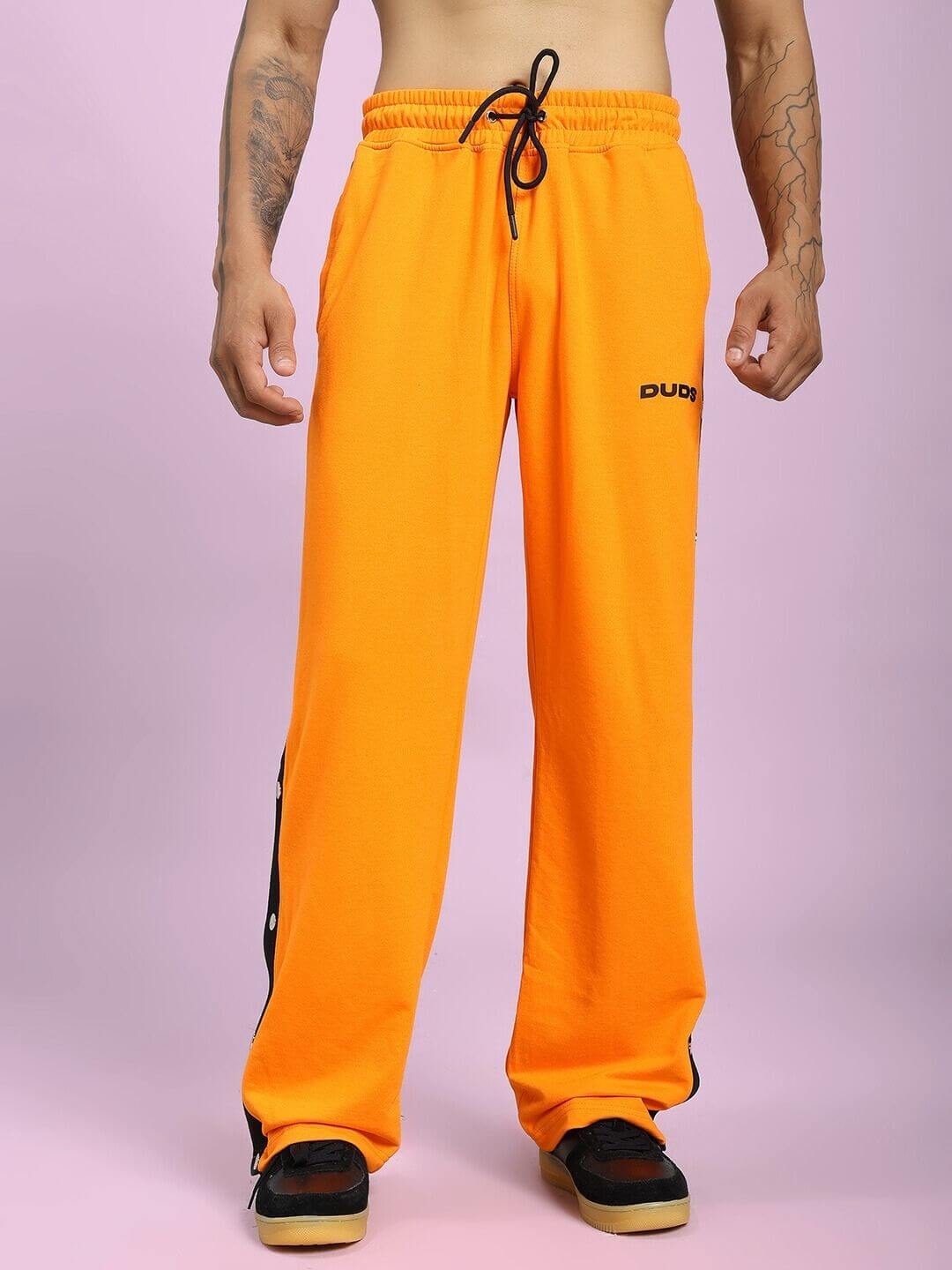 EMBER BOLT SIDE JOGGER IN ORANGE with sleek side stripe and vibrant hue, showcasing comfort and style in a casual wear setting.