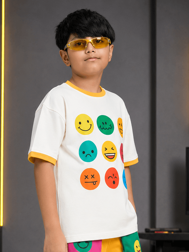 Boy wearing EMOJI VIBES T-SHIRT FOR BOYS GIRL WHITE with colorful emojis and sunglasses, stylish and fun.