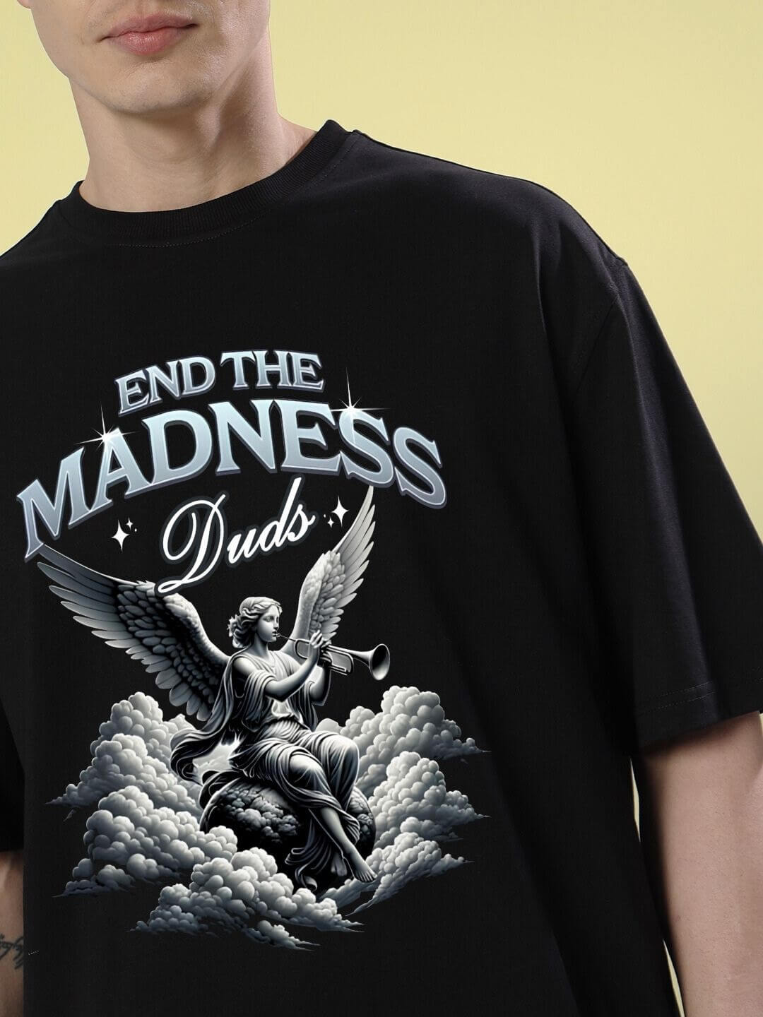 END THE MADNESS OVER-SIZED T-SHIRT BLACK featuring bold graphic design on a model