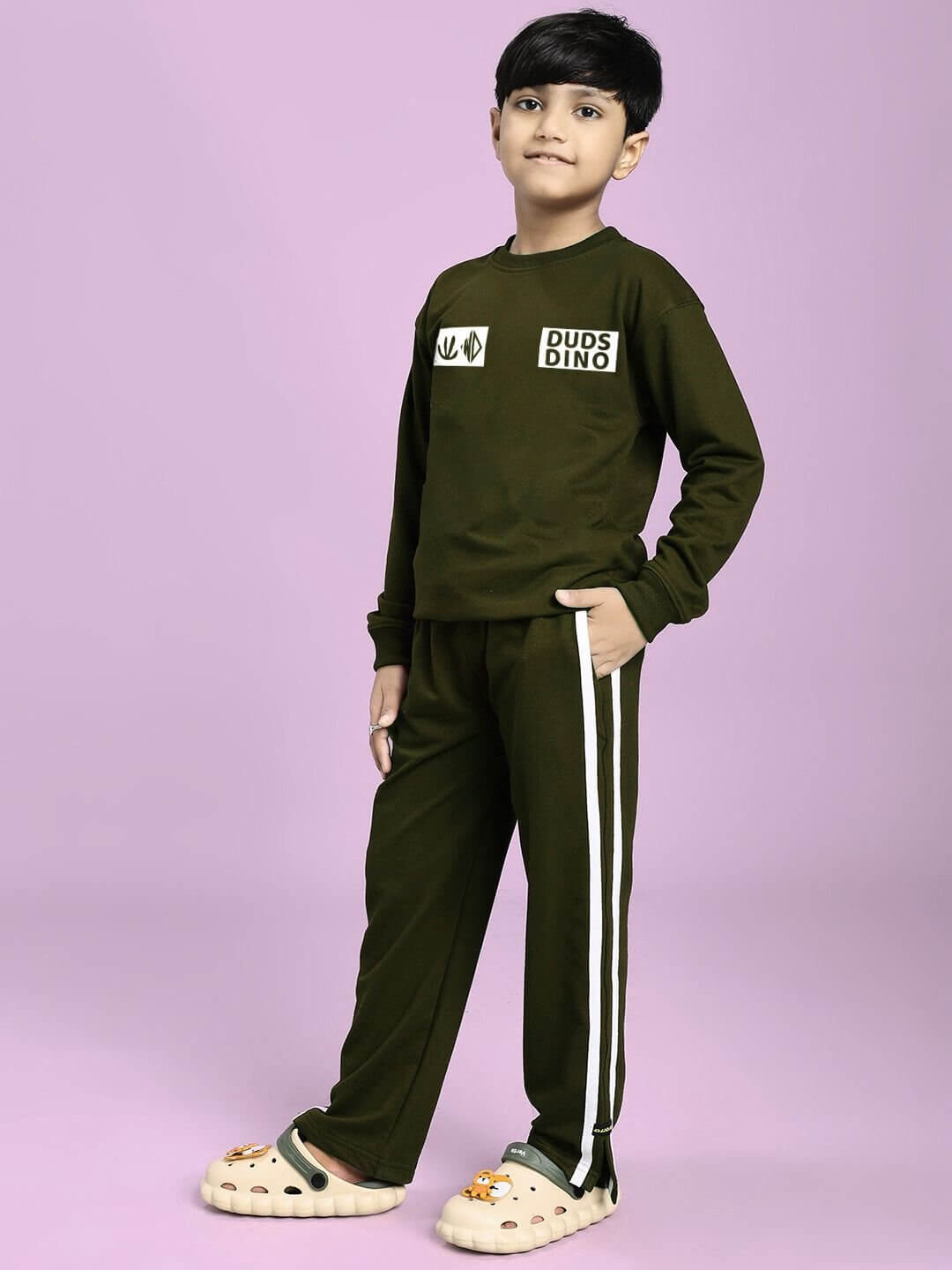 EPIC DINO CO-ORD FOR BOYS GIRLS OLIVE GREEN featuring a kid wearing the stylish two-piece set with dinosaur design details.
