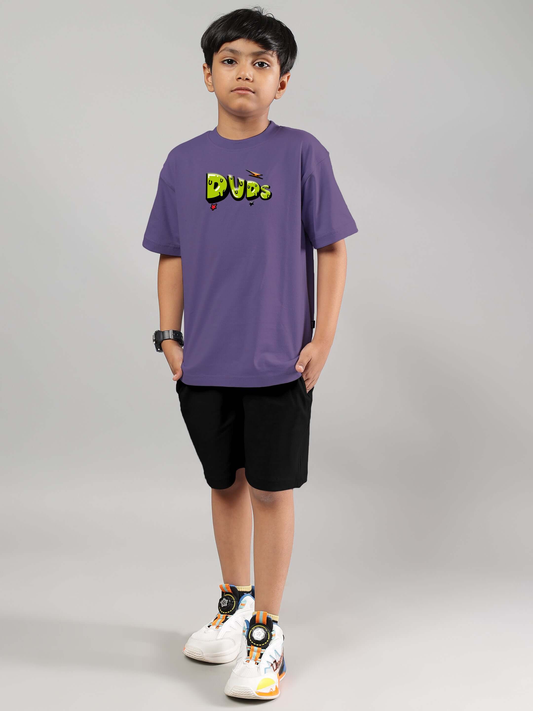 Child wearing ESCAPED TWEETY CO-ORD FOR BOYS GIRLS WISTERIA PURPLE BLACK featuring a bold graphic top and sleek shorts.