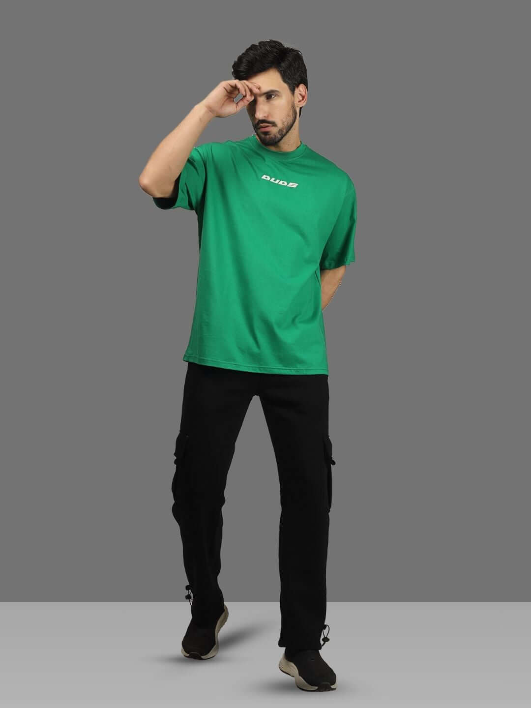 Model wearing oversized green ETCETERA t-shirt with 'Duds' logo, customizable fit available for prepaid orders, handmade quality.
