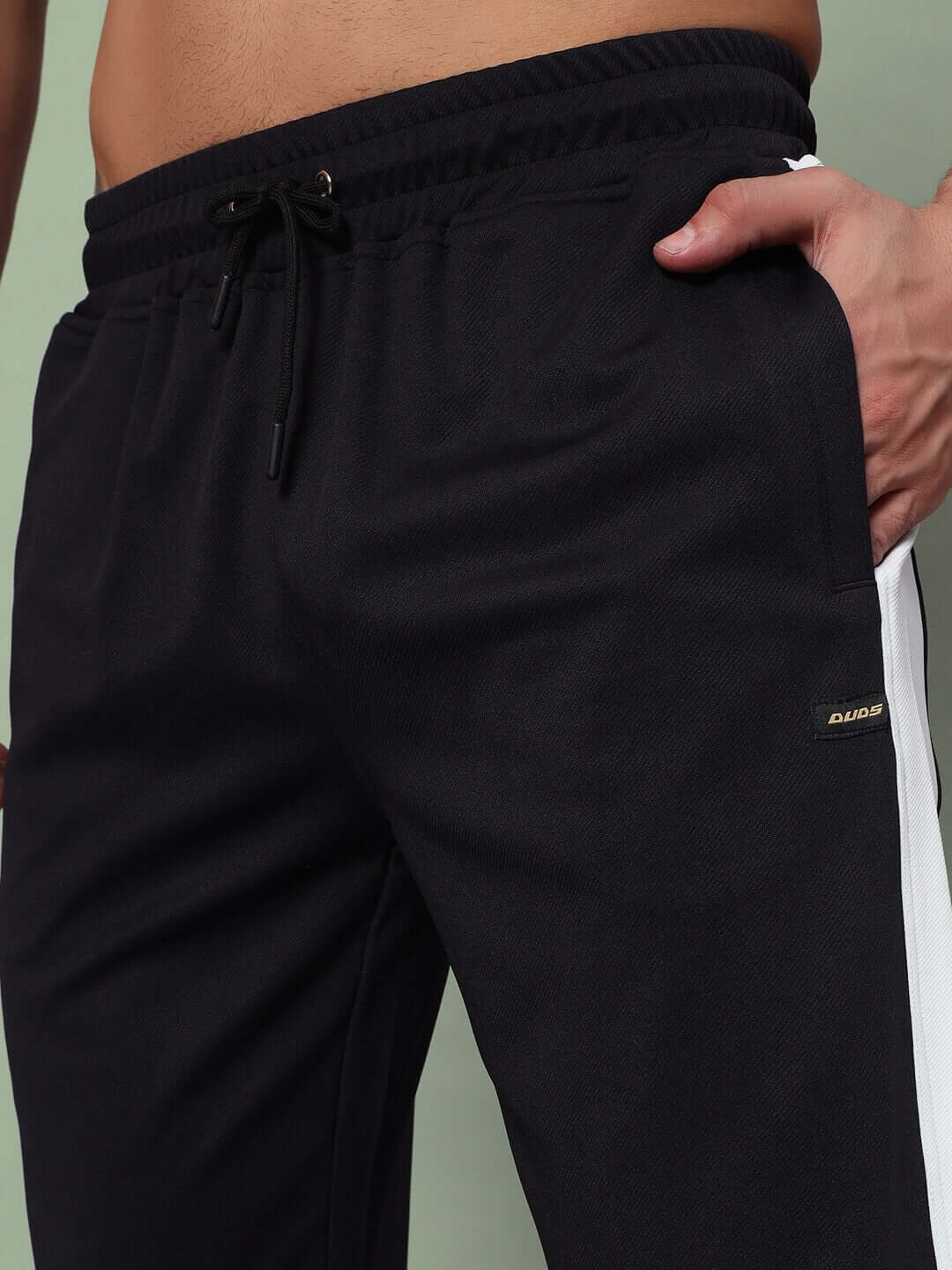 Close-up of black and white Euphoria joggers by DUDS, featuring adjustable drawstring waistband and sleek, tailored fit.