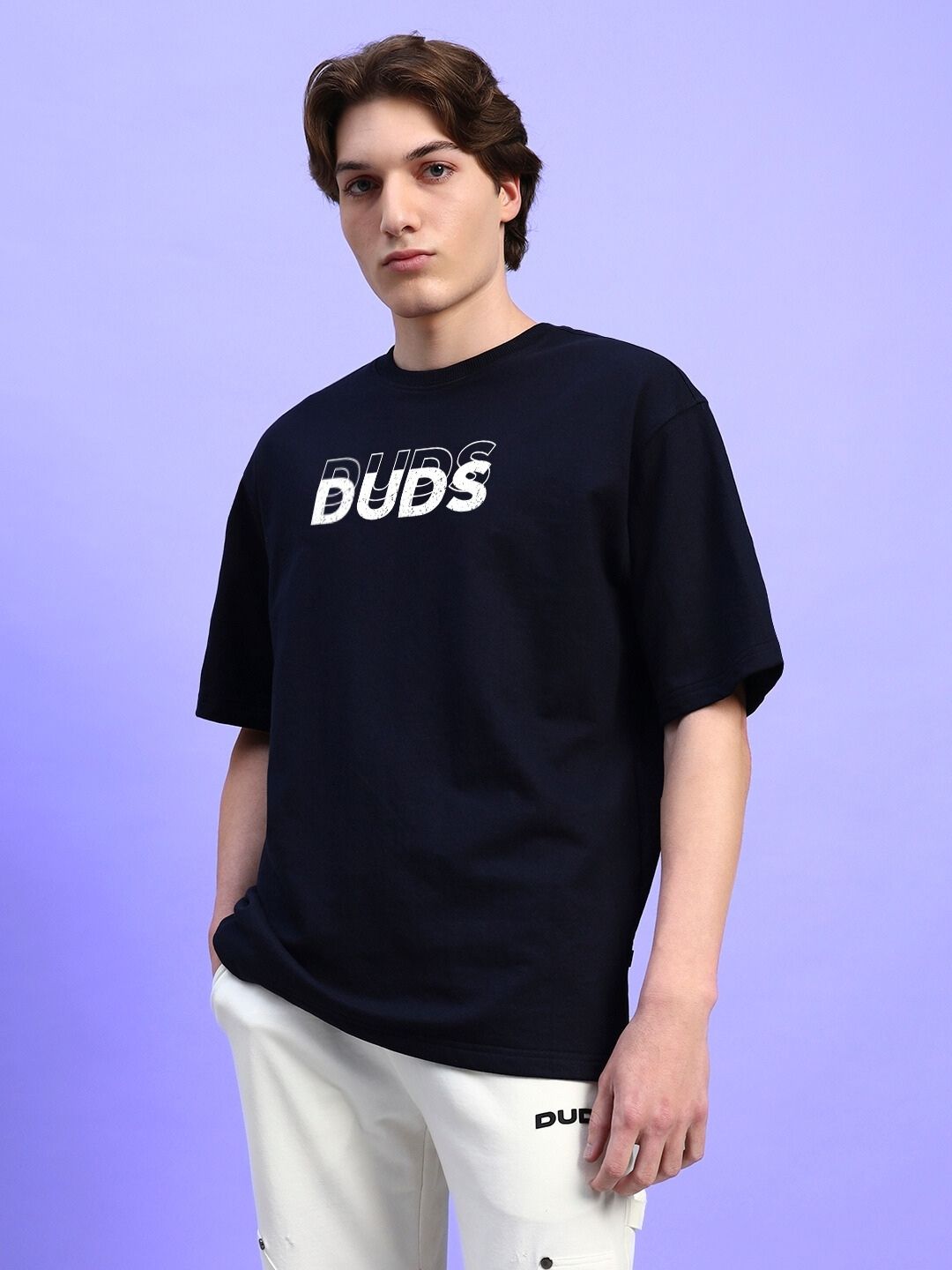 Model wearing EVERYTHING IS TEMPORARY OVER-SIZED T-SHIRT BLACK against a purple background