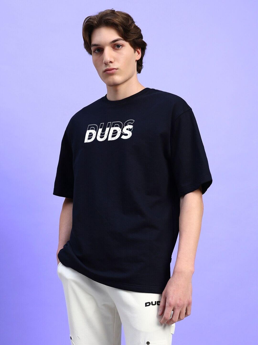 Person wearing EVERYTHING IS TEMPORARY OVER-SIZED T-SHIRT BLACK against light blue background.