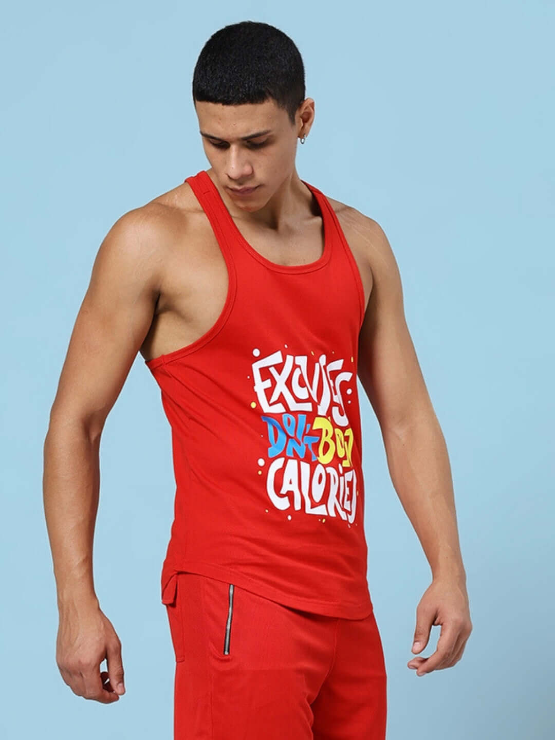 Man wearing EXCUSES DON'T BURN CALORIES PRINTED GYM T-SHIRT RED, showcasing bold fitness motivation attire.