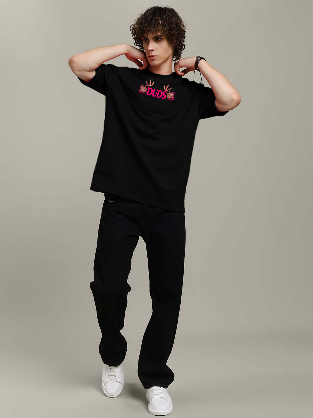 Model wearing EYECONIC OVERSIZED PRINTED T-SHIRT BLACK with graphic print, styled for casual wear.