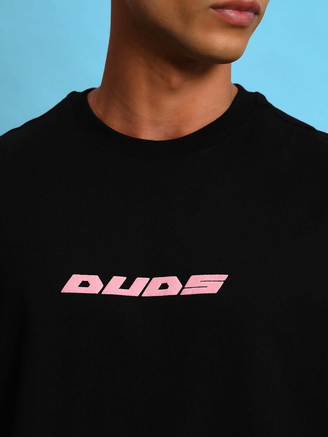 Close-up of EYE BALL PUFF PRINT OVER-SIZED T-SHIRT BLACK with pink logo on chest