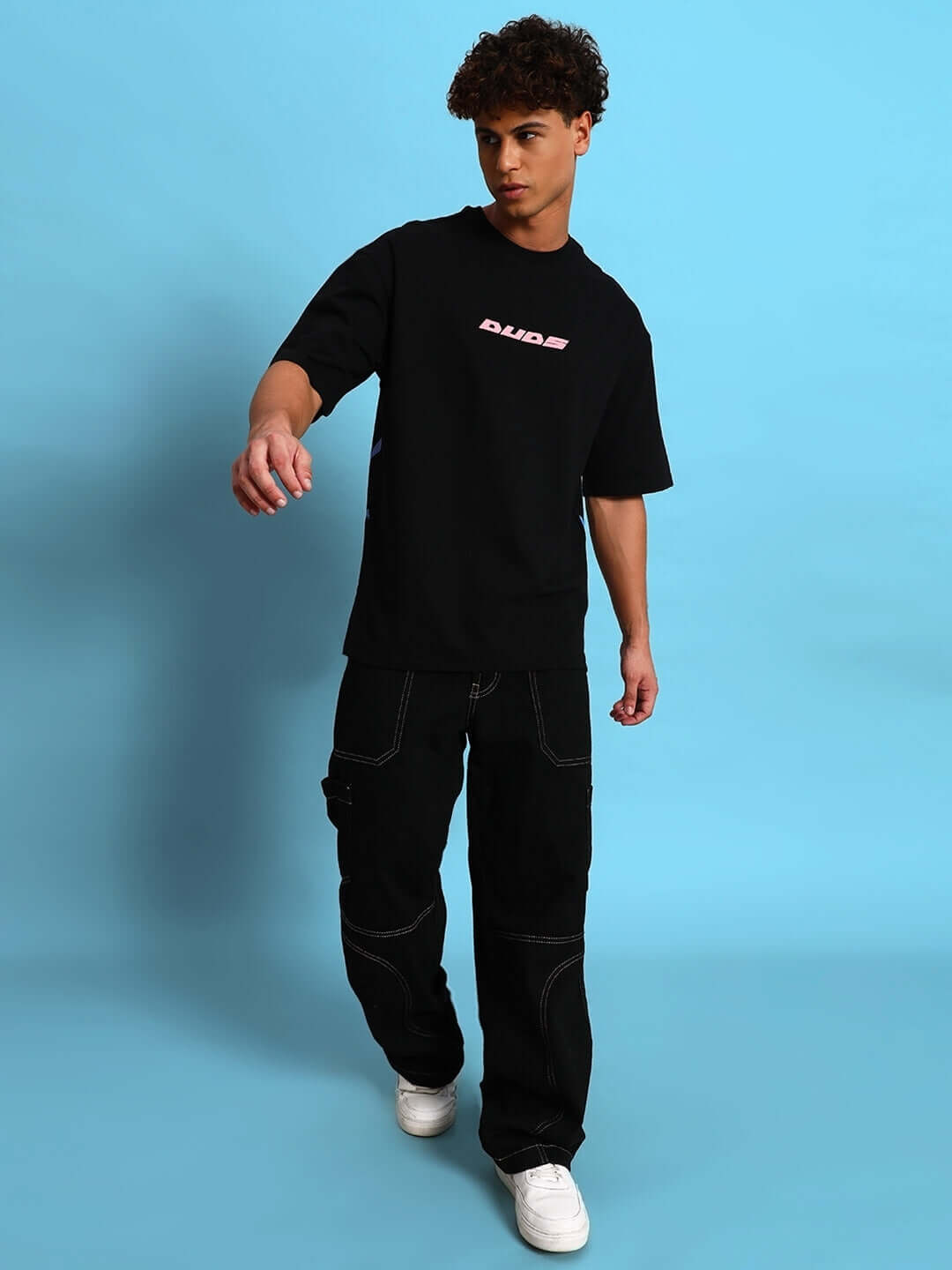 Model wearing EYE BALL PUFF PRINT OVER-SIZED T-SHIRT BLACK, oversized streetwear with puff print design.