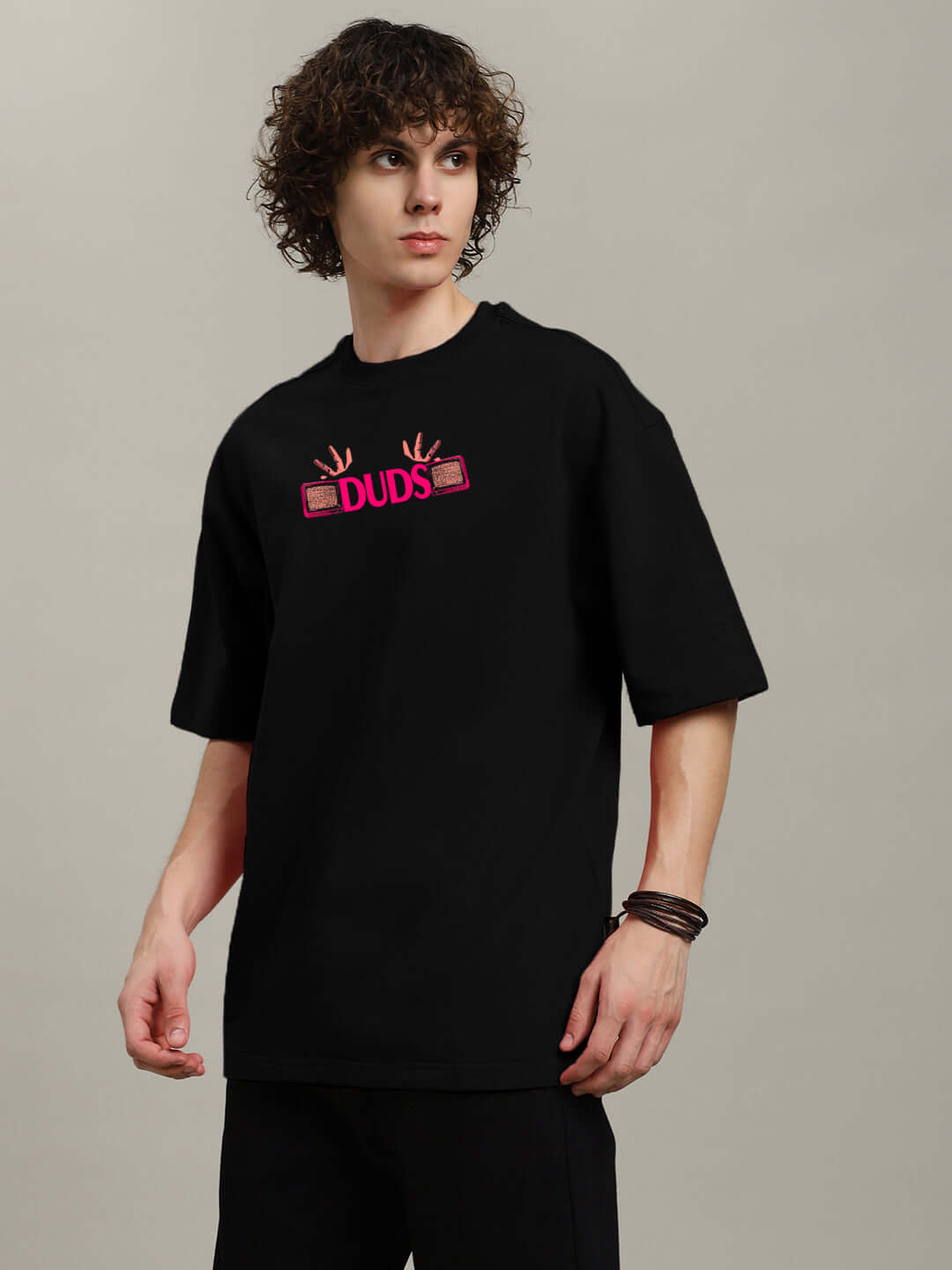 Model wearing EYECONIC OVERSIZED PRINTED T-SHIRT BLACK with striking graphic print, offering relaxed fit and street-style appeal.