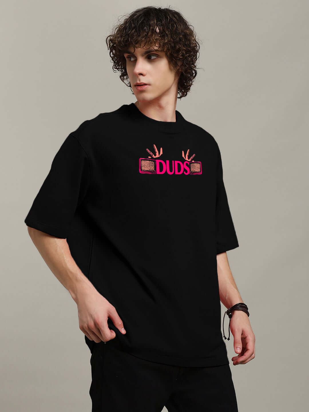 Man wearing EYECONIC OVERSIZED PRINTED T-SHIRT BLACK with graphic print, making a fashion statement.