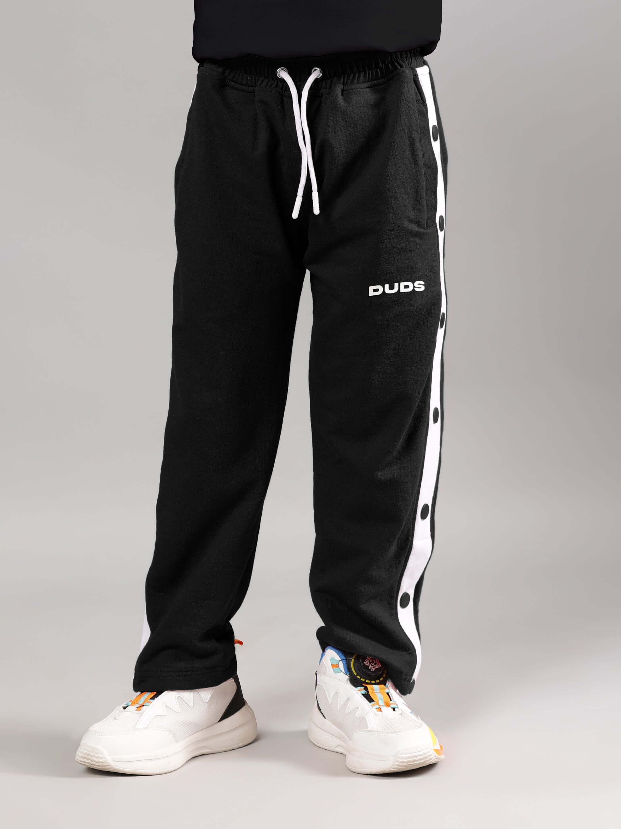 EZEL JOGGER FOR BOYS & GIRLS BLACK by DUDS, featuring comfortable fit with side buttons, ideal for kids' activewear.