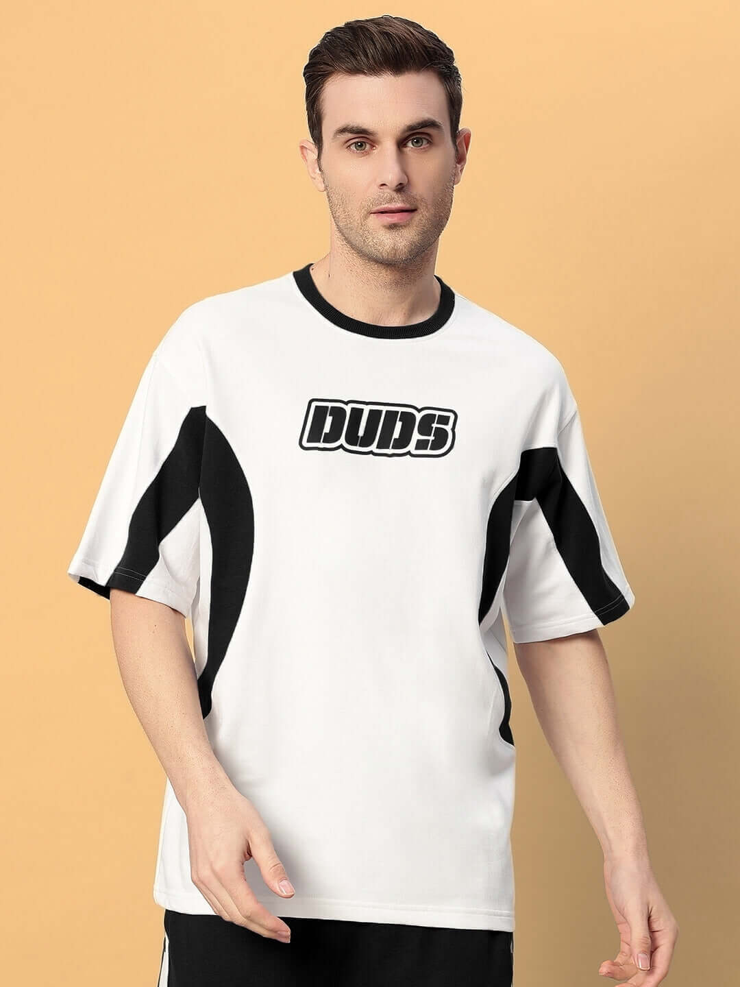 Man wearing EZEL OVER-SIZED T-SHIRT BLACK WHITE with bold streetwear design.