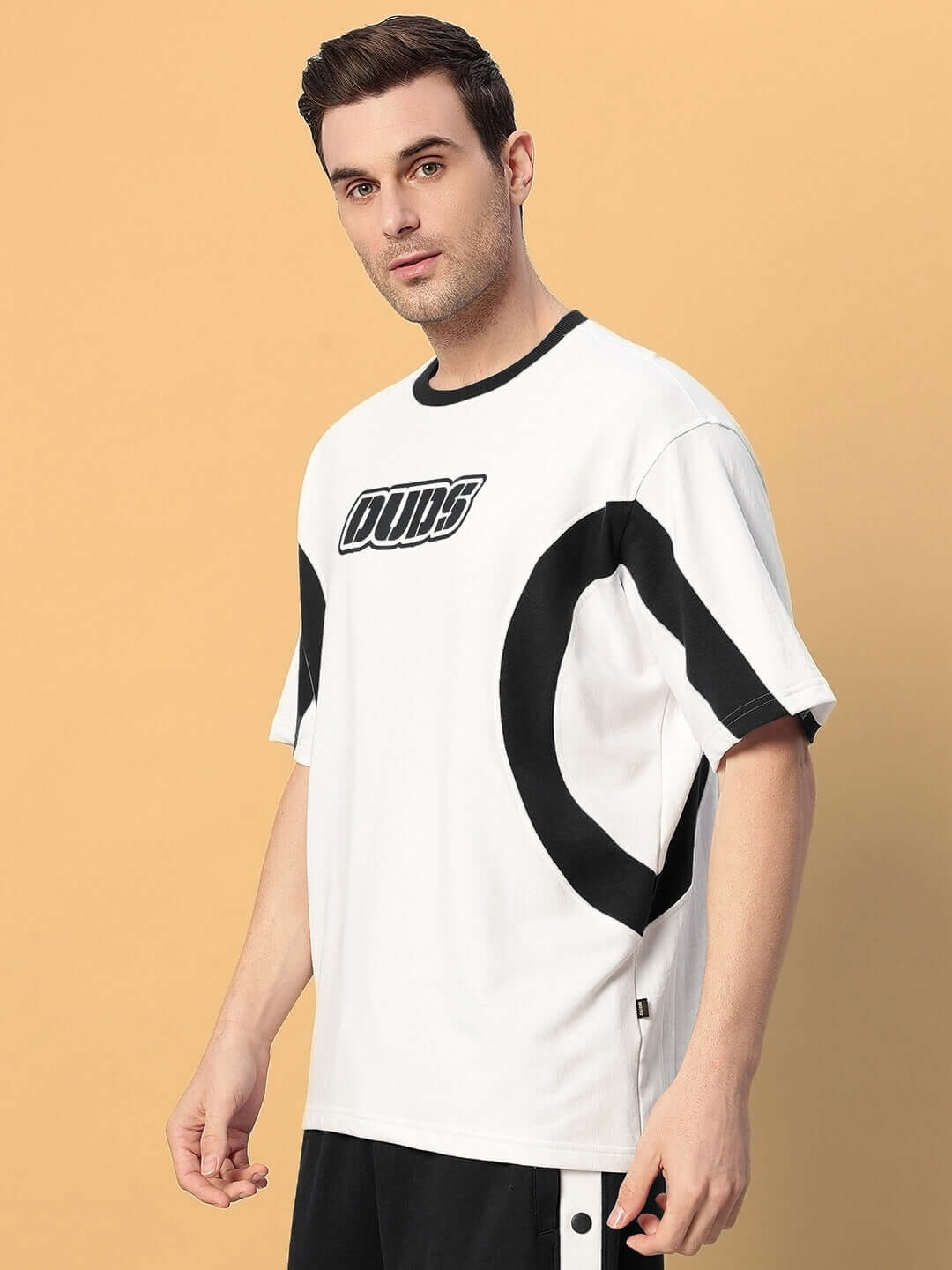 Model wearing EZEL OVER-SIZED T-SHIRT BLACK WHITE, showcasing bold streetwear style with premium breathable cotton.