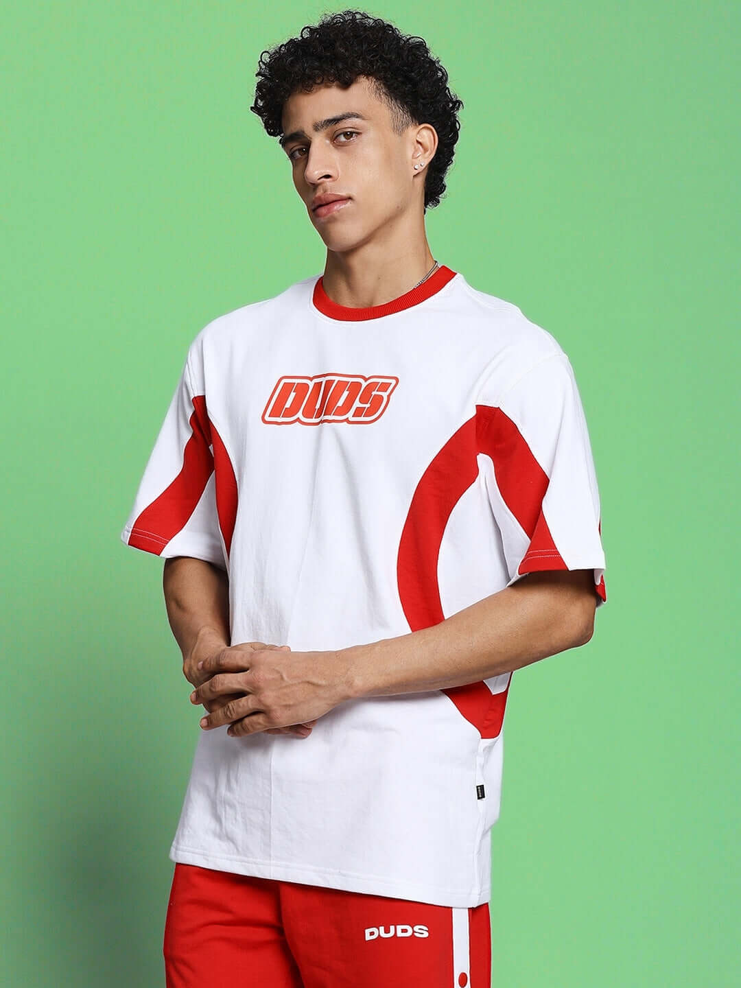Model wearing EZEL OVER-SIZED T-SHIRT WHITE RED with bold streetwear style, featuring red accents on white premium cotton.
