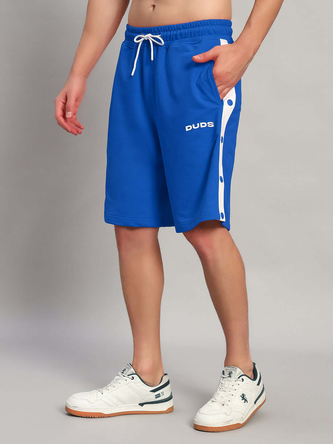 Model wearing EZEL REGULAR FIT COTTON SHORTS BLUE with side buttons and branded logo, perfect for casual or sporty occasions.