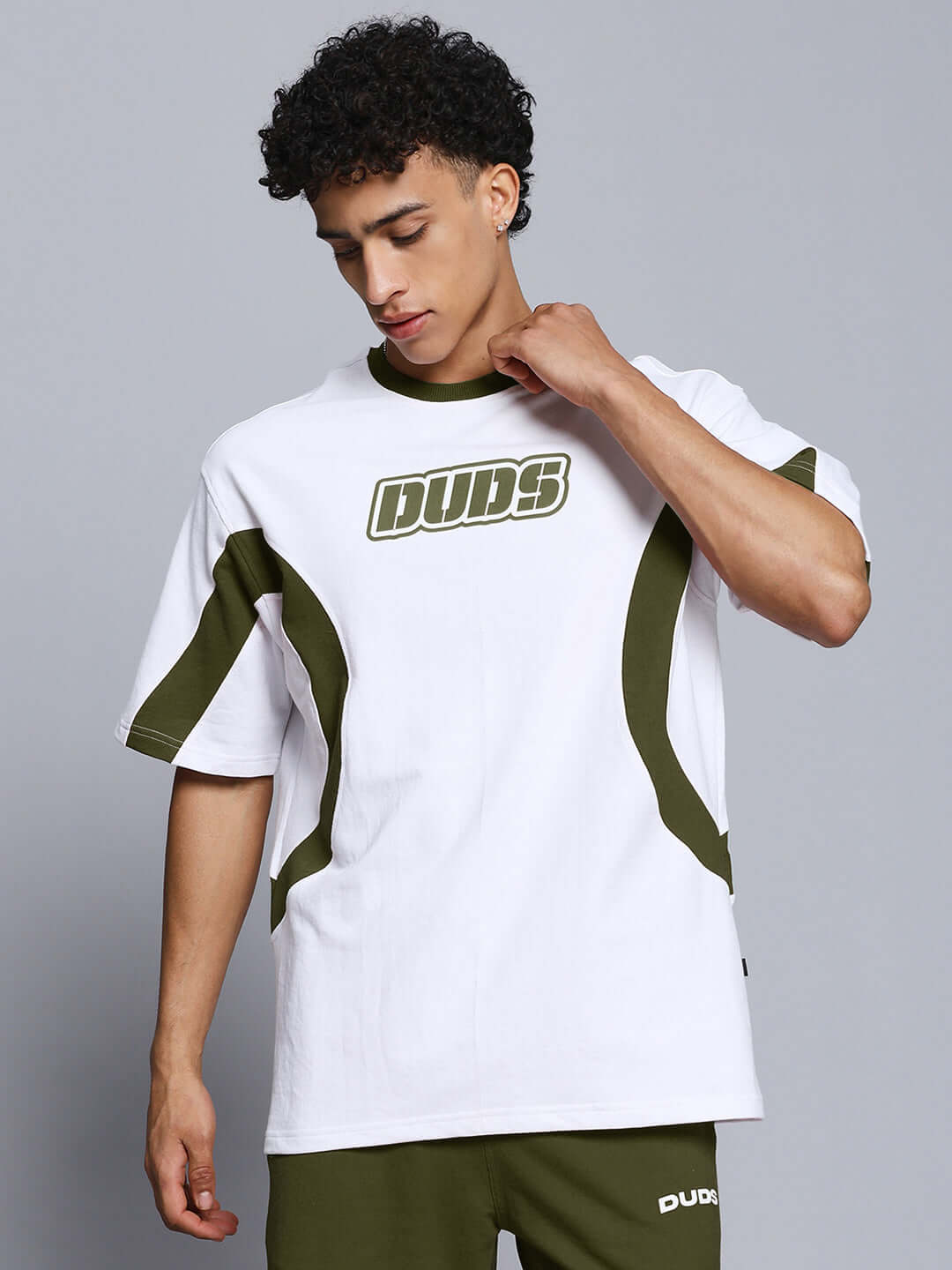 Model wearing EZEL RELAXED FIT CO-ORD SET WHITE-OLIVE showcasing stylish white and olive shirt with olive accents.