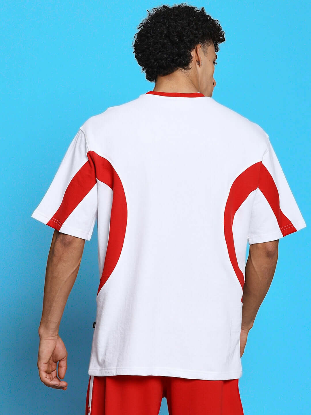Back view of EZEL RELAXED FIT CO-ORD SET WHITE-RED on person, highlighting white and red design details.