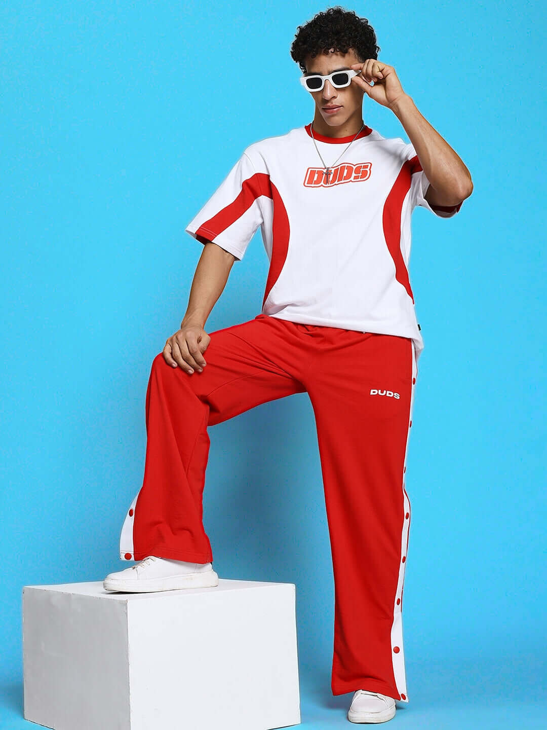 Unisex model wearing EZEL RELAXED FIT CO-ORD SET WHITE-RED, perfect for kids' school or play with breathable cotton and relaxed fit.