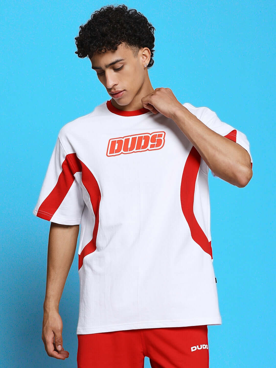 Young person wearing EZEL RELAXED FIT CO-ORD SET WHITE-RED featuring bold graphics and relaxed fit style, perfect for everyday comfort.