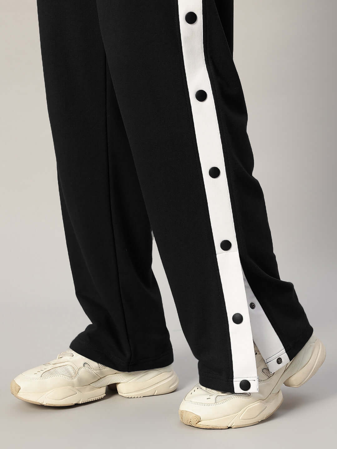 Close-up of EZEL RELAXED FIT CO-ORD SET WHITE-BLACK pants with black and white side stripes.