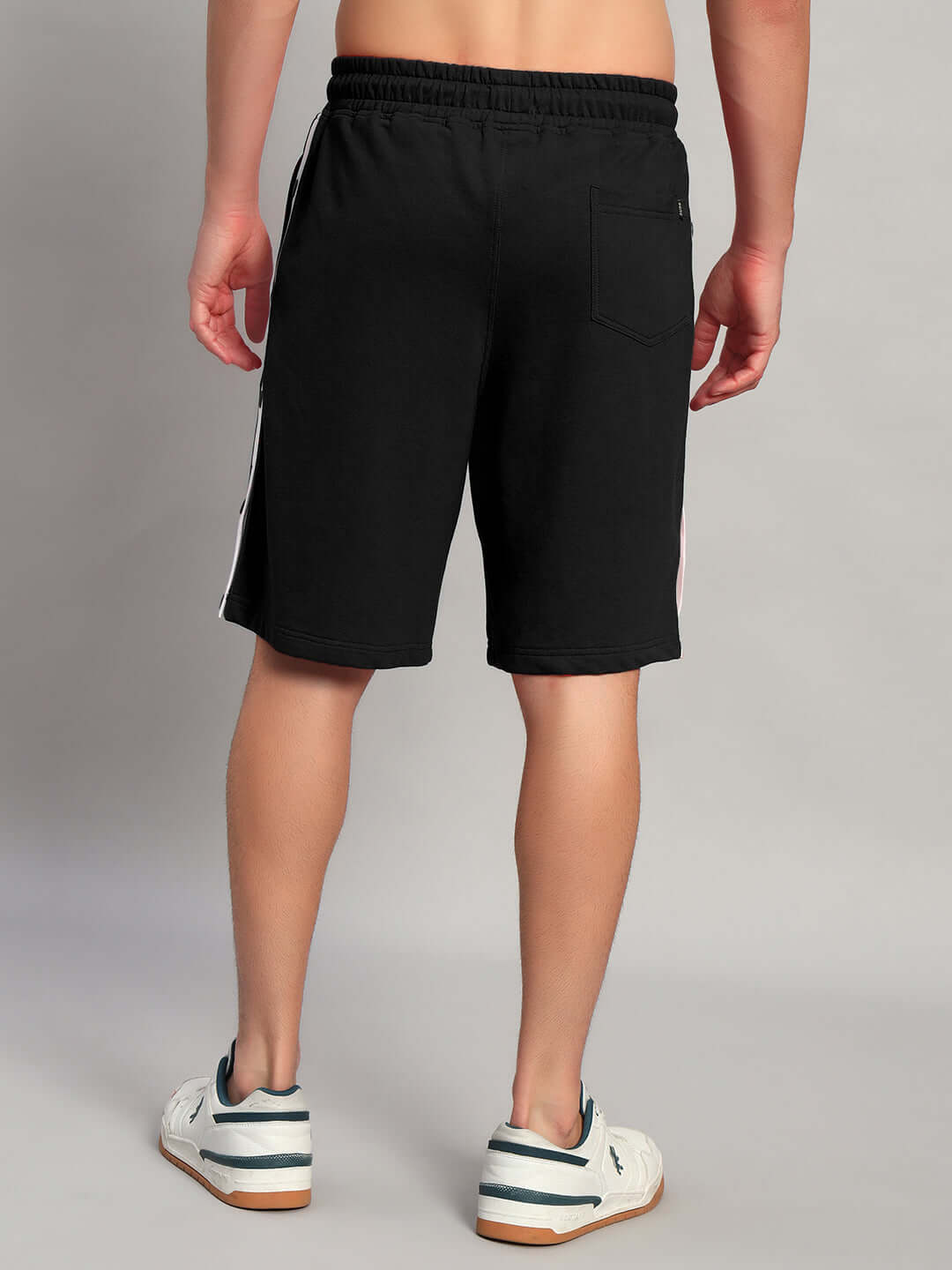 Back view of Ezel Regular Fit Shorts Black cotton worn by a male model, showcasing the fit and comfort of the stylish WEAR DUDS shorts.